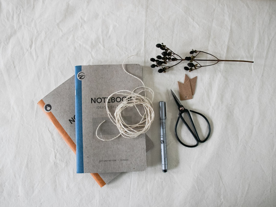Person using a laptop with a green screen.